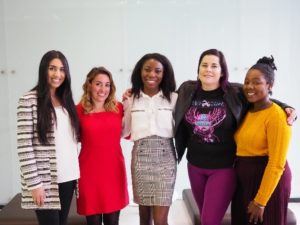 A group  of 5 women, including Amber, smile for the camera.