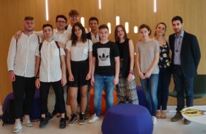 A group picture of the students in the program in front of a Cisco logo in our office in Rome, Italy.