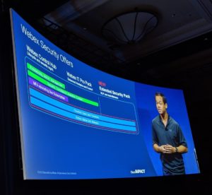 A giant screen at Cisco Impact where Jono is giving a speach on Webex Security Offers.