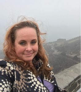 Claranne smiles on top of the The Great Wall of China.