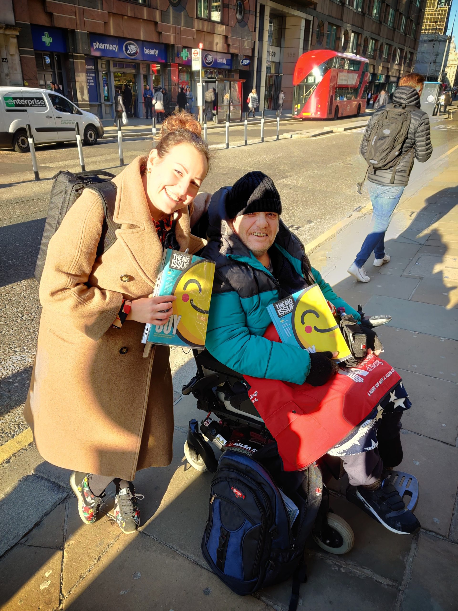 Liz smiles with Jason, one of the sellers of The Big Issue.