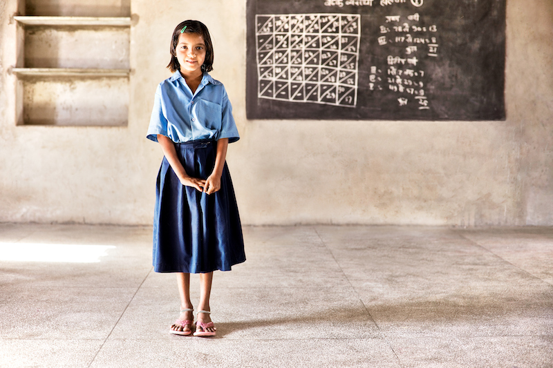 girl standing in front of chalk board