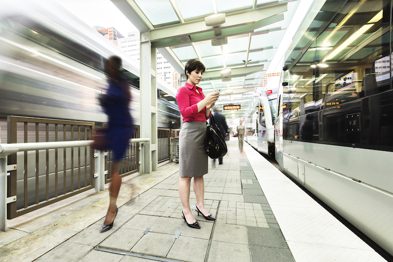 woman standing between metro lines
