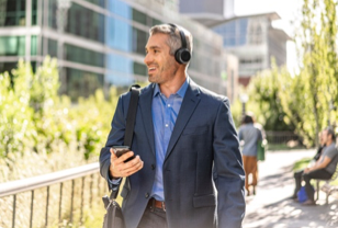 Man walking on sideway wearing new Cisco Headset 700 Series