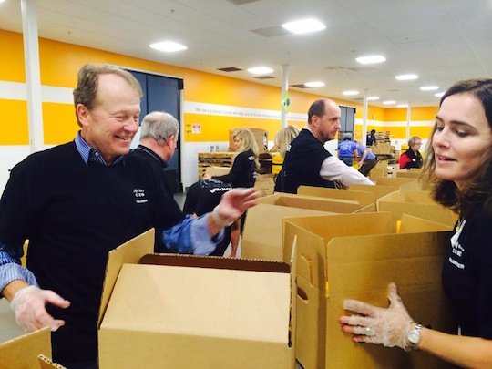 Cisco Chairman and CEO John Chambers sorts food with employee volunteers at the Second Harvest Food Bank of Santa Clara and San Mateo Counties