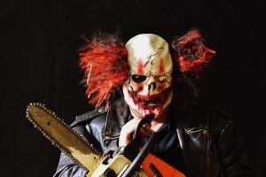 Evil clown with chainsaw. 