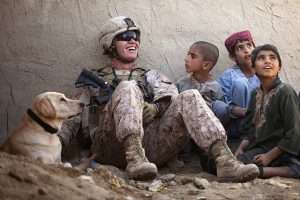 Soldier with children and dog. 