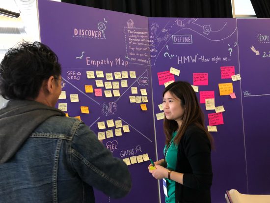 DevNet's Casey Tong discusses API design at the Design Thinking booth at DevNet Create