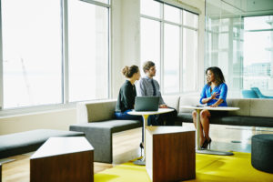 Businesswoman leading meeting with colleagues in office