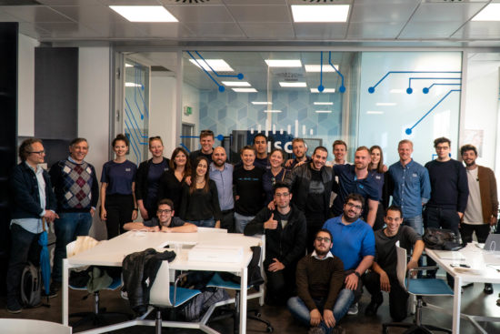 A large group of Cisco Sales Associate Program (CSAP) employees smile for a team photo.