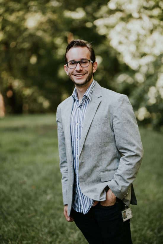 Emilio smiling in his glasses, a sport coat, and Cisco badge.