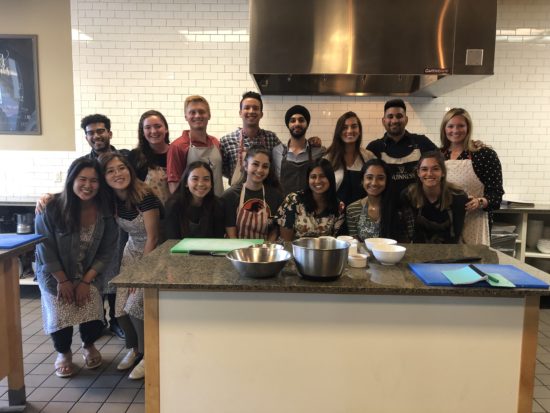 Alisha alongside her team at a cooking class.