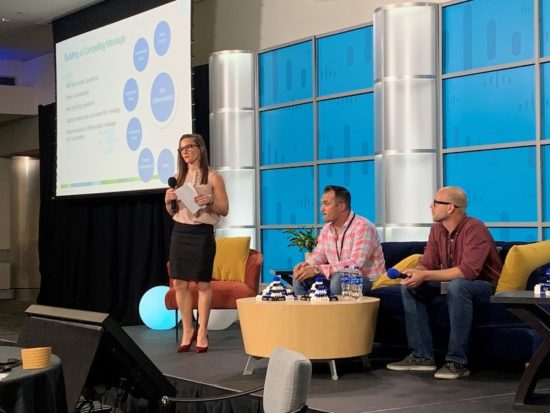 Jeane presenting on stage at Cisco next to two of her peers.