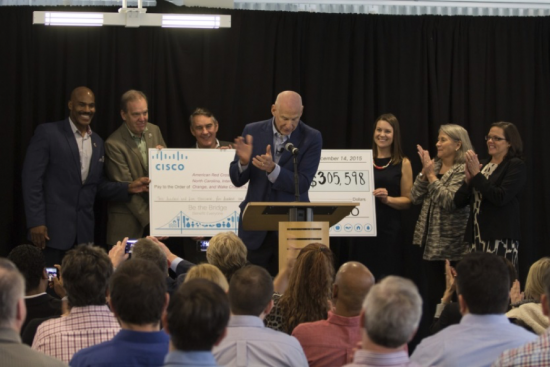 Ed Paradise, VP of engineering, presenting collective check to RTP Campus local nonprofit partners