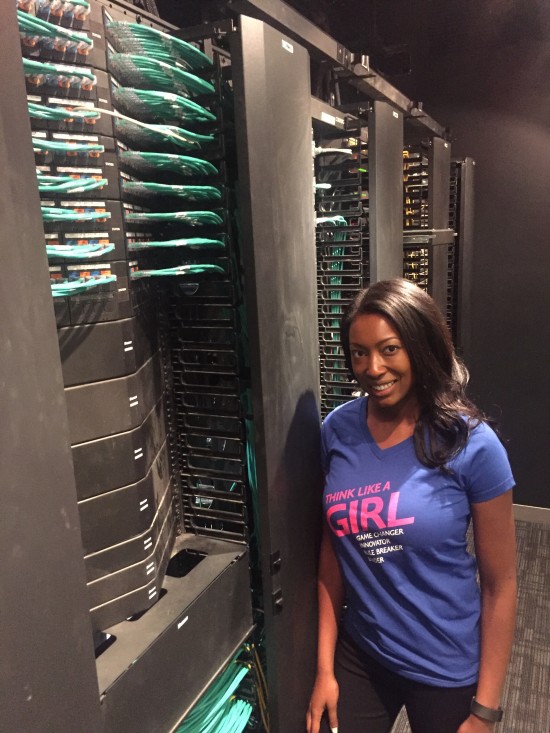 Aisha Bowe, CEO STEMboard and guest speaker for Girls Power Tech, in front of the rack space at the Cisco office.