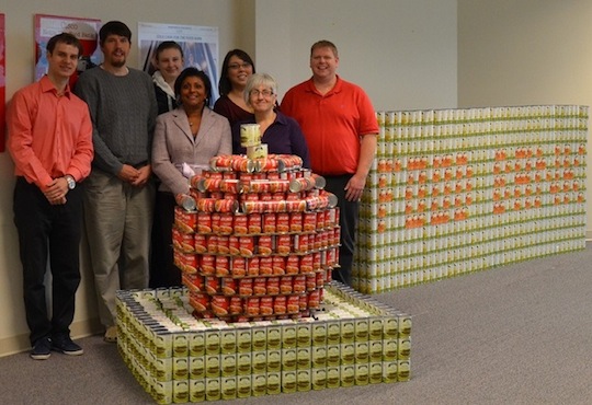 The Kanata R&D team proudly displays their cansculpture of an apple to support their local food bank. 