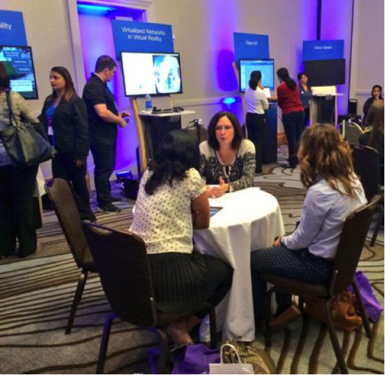 Rebecca Jacoby, Senior Vice President of Operations at Cisco, speaks with attendees about career development at Cisco’s Innovation Café during the conference.