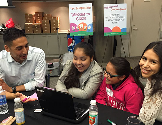 Employee volunteers help students learn about programming on Code.org