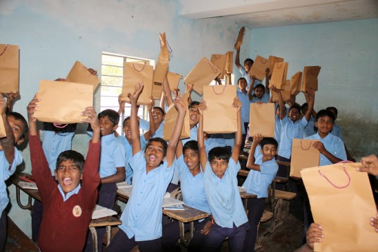 Food packages that Cisco employees put together are delivered to students at a government-run school.