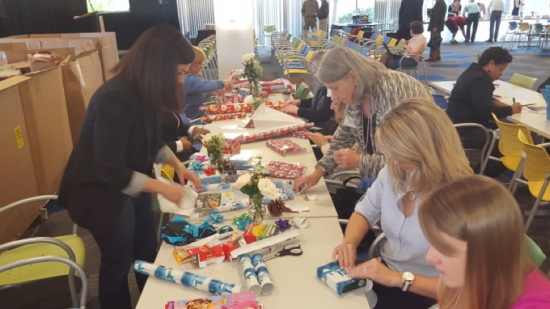 Cisco Volunteers wrapping holiday gifts for families of Interact of Wake County 