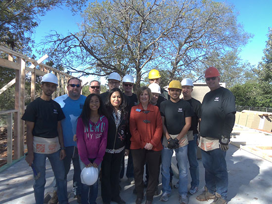 Soon-to-be homeowner Gloria Alamos and her daughter with Beth Kolman and the team of Cisco employee volunteers with Waco Habitat for Humanity.