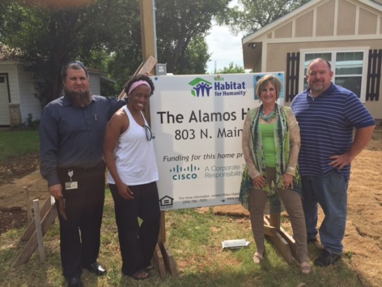 Cisco volunteers in front of the home they helped build for Gloria Alamos and her family