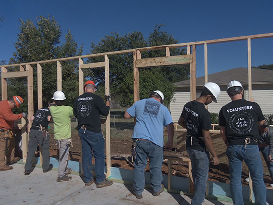 Cisco employee volunteers build walls for the new home of Gloria Alamos, whose previous house was destroyed when a fertilizer plant exploded in West, Texas, on April 17, 2013. 