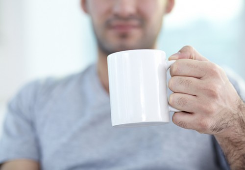 Close-up of male hand holding mug